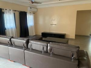 a leather couch sitting in a living room at Amie's Villa Apartment in Jarbang