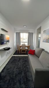 a living room with a couch and a table at Doce Lar 2 in Pouso Alegre