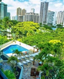 an aerial view of a swimming pool with a city skyline at Luana Waikiki in Honolulu