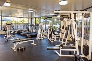 a gym with several treadmills and exercise machines at Luana Waikiki in Honolulu