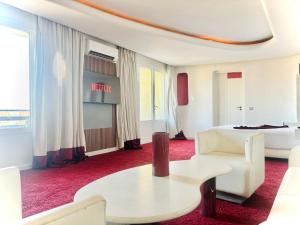 a hotel room with a bed and a table at La Renaissance hôtel Marrakech in Marrakesh