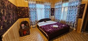 a bedroom with a bed with a fireplace and curtains at Hotel First Kashmir in Srinagar