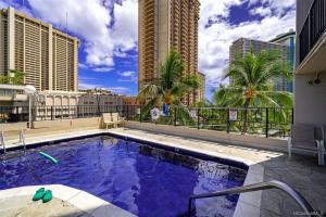 a swimming pool on the roof of a building at Penthouse unit at Palms Waikiki in Honolulu