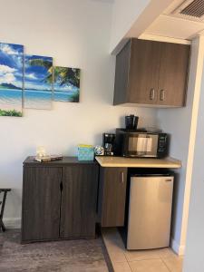 a kitchen with a counter top with a microwave at Penthouse unit at Palms Waikiki in Honolulu