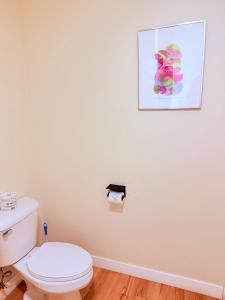 a bathroom with a toilet and a picture on the wall at The Kingsley Suites in Kingsley +10 photos