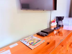 a wooden counter top with a coffee maker on it at The Kingsley Suites in Kingsley