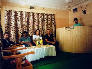 a group of men sitting around a table in a room at Hotel First Kashmir in Srinagar