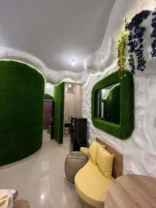 a living room with green plants on the wall at Amed Sea Resort in Amed
