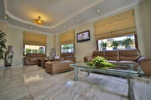 a living room with leather furniture and a table at Sunny Hotel 1 in Hanoi