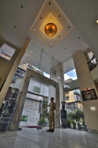 a man standing in front of a building at Sunny Hotel 1 in Hanoi