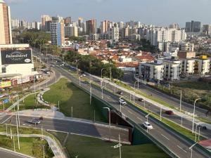 a city with a highway and a city with buildings at Praia Litorânea in São Luís