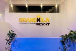 a sign for a grand malia resort on a wall at Grandmila Resort in Anuradhapura