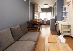 a living room with a couch and a kitchen at Tasogare Baycity in Hakodate