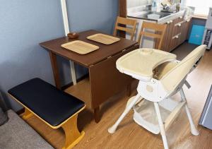 a high chair next to a desk and a high chair with a high chair at Tasogare Baycity in Hakodate +25 photos
