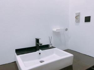 a white sink in a white room with at Homestay Sri Aman in Simanggang