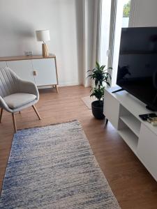 a living room with a television and a chair at Casas Morgado in Valada