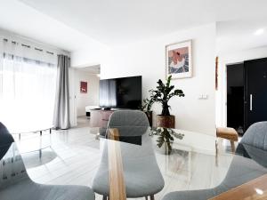 a living room with a glass table and chairs at Casa Relán by FTV HOLIDAYS HOMES in Villaverde
