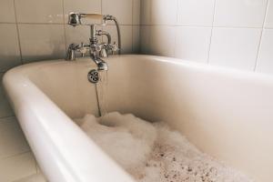 a bath tub filled with lots of snow at The Little Thatch Cottage in Greyton +12 photos