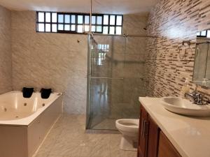 a bathroom with a shower and a toilet and a sink at Cabaña Barichara in Barichara +4 photos