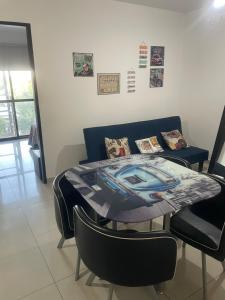 a table and chairs in a room with a couch at 37 Intendente Doctor Jaime Gil in Río Cuarto