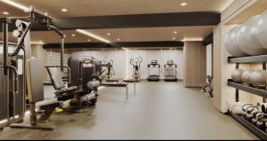 a gym with treadmills and machines in a room at Warm & Exclusive 2 BR in San Antonio