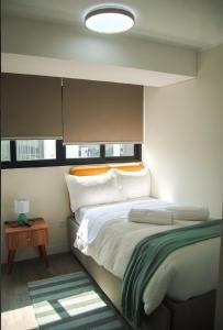 a bedroom with a large bed and a window at Warm & Exclusive 2 BR in San Antonio