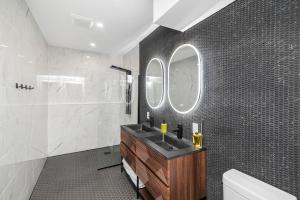 a bathroom with a sink and a mirror at Cozy Spacious 2BR Suite with Parking & Wi-Fi in Hamilton