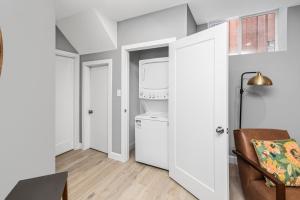 a kitchen with a washer and dryer in a room at Cozy Spacious 2BR Suite with Parking & Wi-Fi in Hamilton