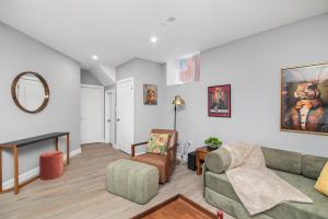 a living room with a couch and a chair at Cozy Spacious 2BR Suite with Parking & Wi-Fi in Hamilton