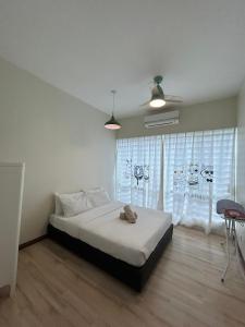 a bedroom with a bed and a large window at SDC Suite Home 6 in Lahad Datu +7 photos