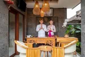 a man and a woman standing in front of a table at Govala Usada Ubud Villa in Ubud +153 photos