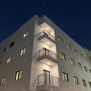 a white building with balconies on the side of it at Sunshine Flat in Al Khobar