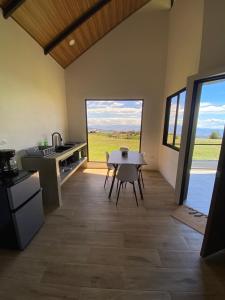 a kitchen and dining room with a table in a room at Cabaña Vistas de Lujo in Fraijanes +15 photos