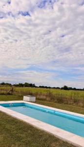 a swimming pool in the middle of a field at Quinta La Carlota in Navarro