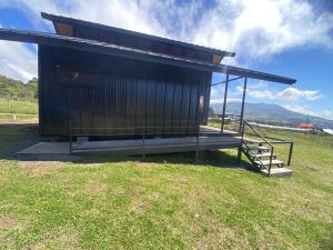 a small building with a staircase in a field at Cabaña Vistas de Lujo in Fraijanes
