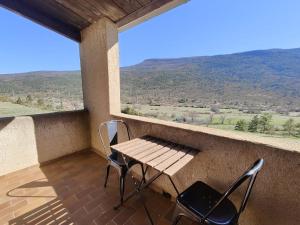 a table and chairs on a balcony with a view at Hostel du Canyon in La Palud-sur-Verdon +40 photos