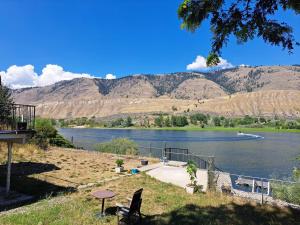 a view of a lake with mountains in the background at Private Bedroom at Riverfront House in Kamloops +7 photos