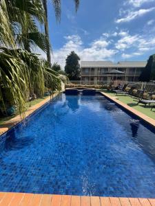 a large pool with blue water in front of a building at Paddlewheel Motel in Echuca