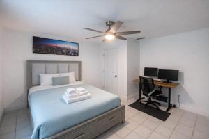 a bedroom with a bed and a desk with a computer at Stunning Home in Plano! in Plano