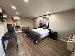 a hotel room with a bed and a desk at Super 8 by Wyndham Visalia in Visalia +34 photos