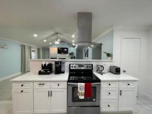 a kitchen with white cabinets and a stove top oven at Stunning Home in Plano! in Plano