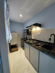 a kitchen with a sink and a stove top oven at Casa De La Suerte in Chapulco