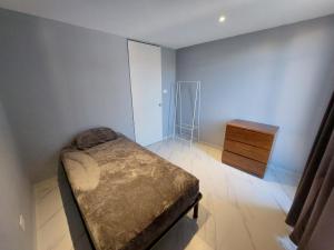 a small bedroom with a bed and a dresser at Casa De La Suerte in Chapulco