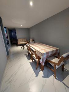 a dining room with a wooden table and chairs at Casa De La Suerte in Chapulco