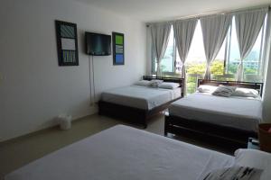 a room with two beds and a window at Costa Azul Suites 403 in Santa Marta +62 photos