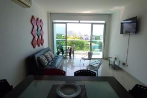 a living room with a couch and a table at Costa Azul Suites 403 in Santa Marta