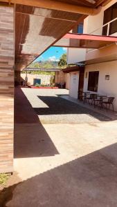 a shadow of a building with tables and a patio at Macaws Villa in Ciudad Cortés