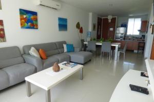 a living room with a couch and a table at Costa Azul Suites 401 in Santa Marta