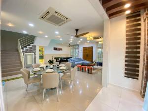 a dining room and living room with a table and chairs at Ruma Relaxz by Jeffery Lam Home Management in Malacca