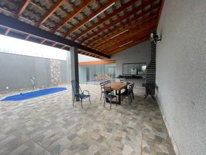 a dining room with a table and chairs in a house at Casa de lazer privativa in Barretos +9 photos